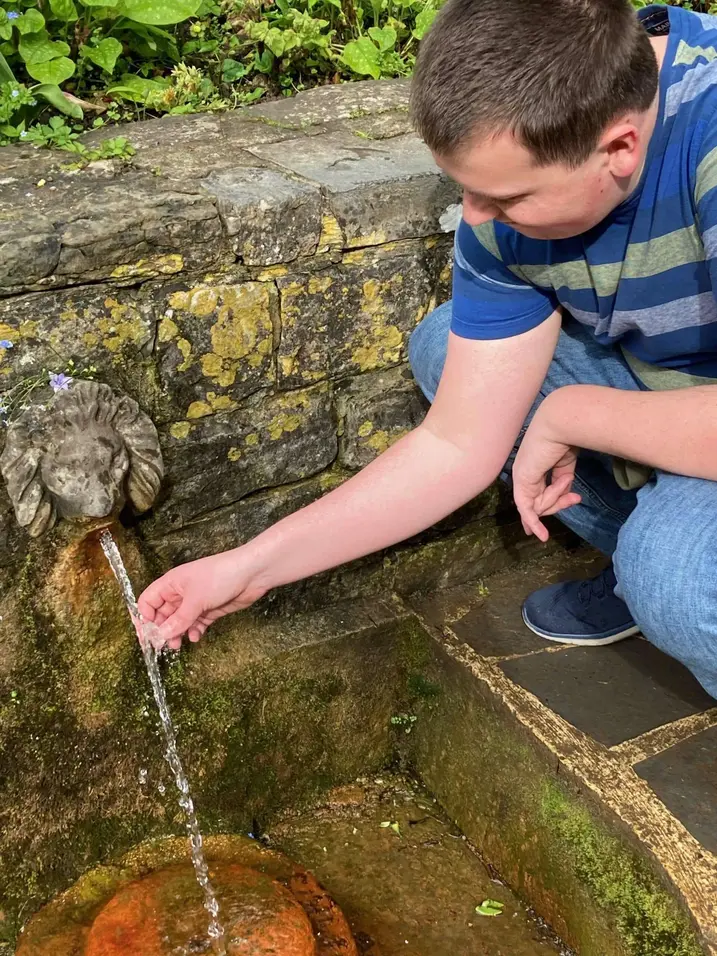 Jonathon cleansing crystals at the Chalice Well in Glastonbury